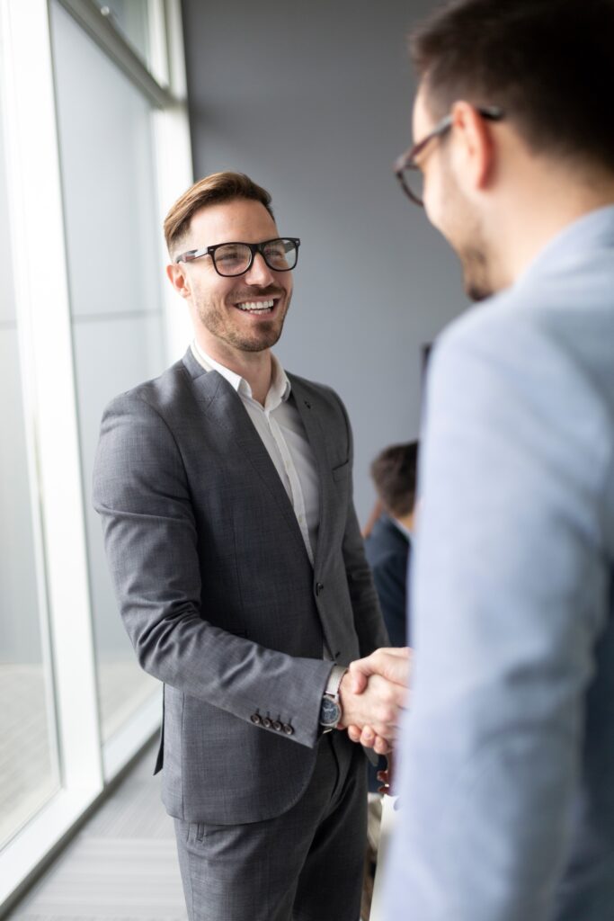 Business people shaking hands, finishing up successful meeting